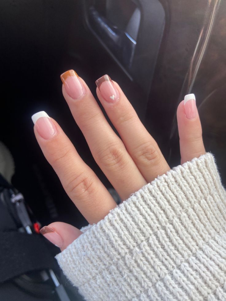 Sophisticated Nude and Pastel Nail Design with Whimsical Heart Detail