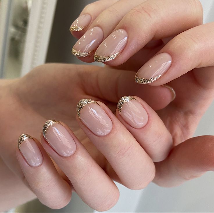 Sophisticated Elegant Nude Nail Design with Delicate Gold Glitter Tips