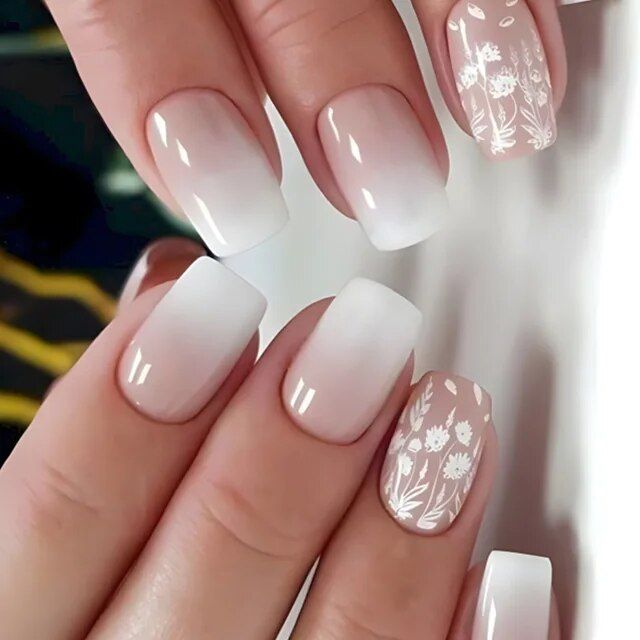 Elegant Ombre Nails with Floral Designs: A Fresh and Modern Manicure for Any Occasion.