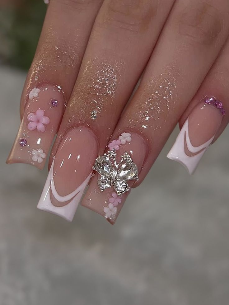 Elegant Pink and White Floral Nail Design with Rhinestones for a Feminine Touch.