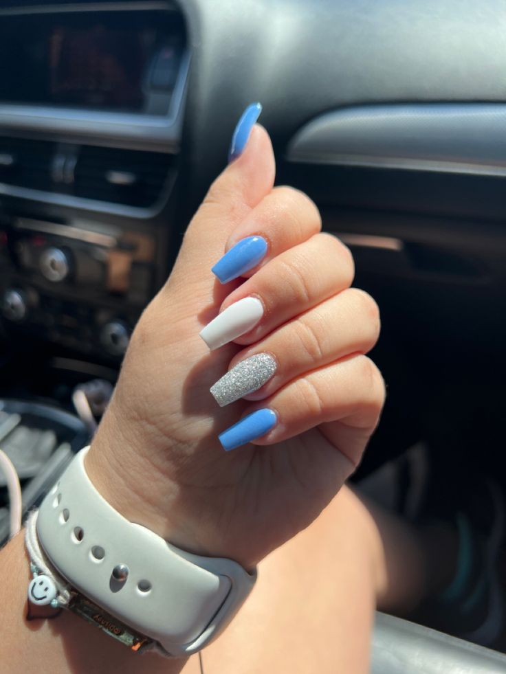 Striking Summer Nail Design: Vibrant Blue and White with Glitter Accents