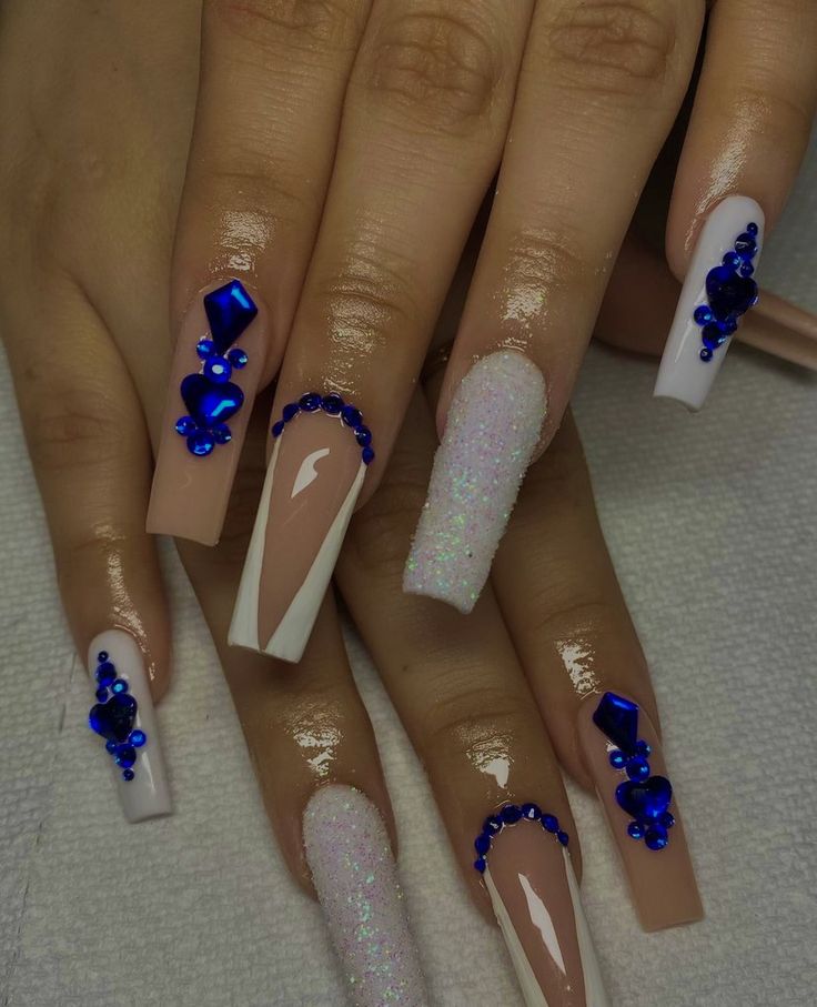 Chic Nail Art: Nude and White Design with Glitter and Glamorous Blue Rhinestone Accents.