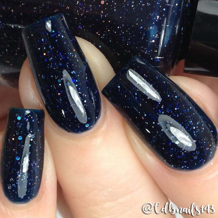 Elegant Sparkling Navy Blue Nail Design with Glossy Finish and Glitter Accents.