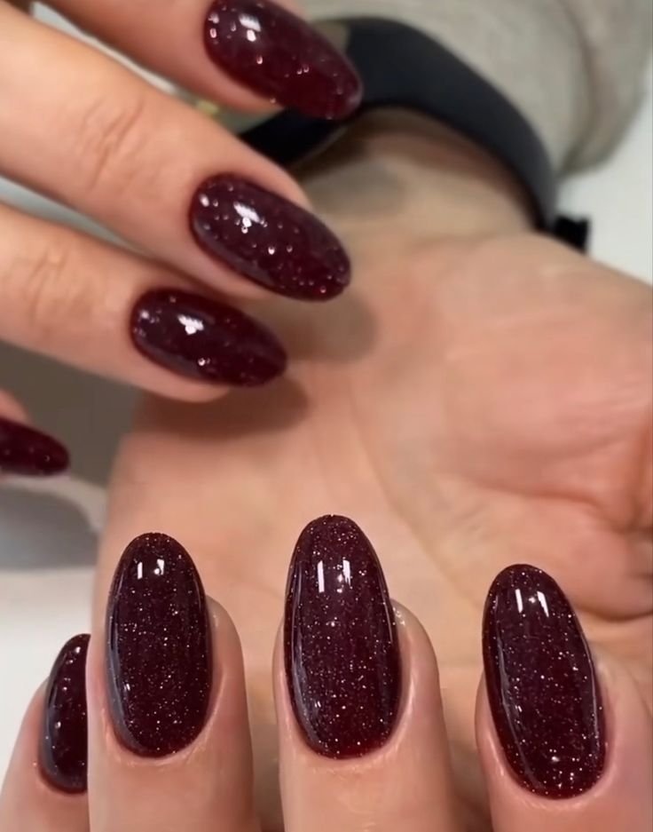 Elegant Glistening Burgundy Nails with Shimmering Finish