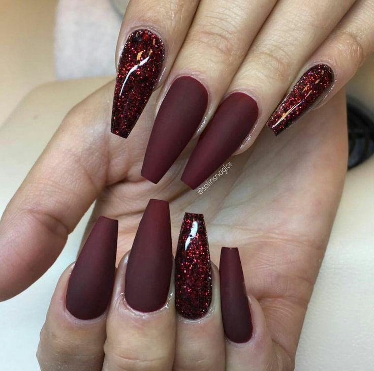 Striking Bold Red Matte Almond Nails with Sparkling Accents for Elegant Sophistication.