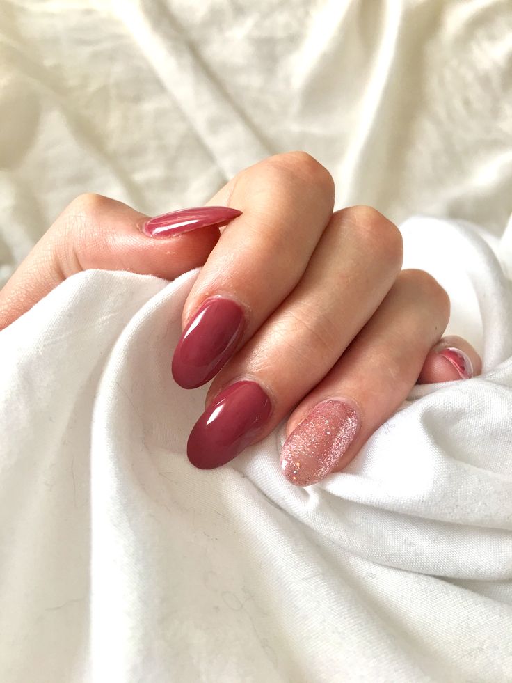 Chic Almond-Shaped Burgundy Nail Design with Sparkling Accent for Any Occasion