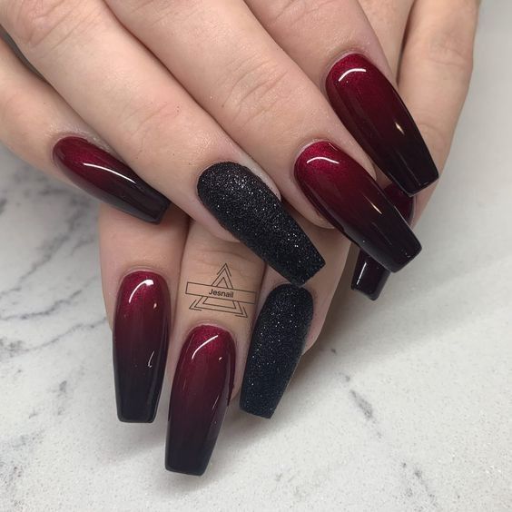 Elegant Burgundy Ombre Nails with Glossy Finish and Glam Black Glitter Accent.