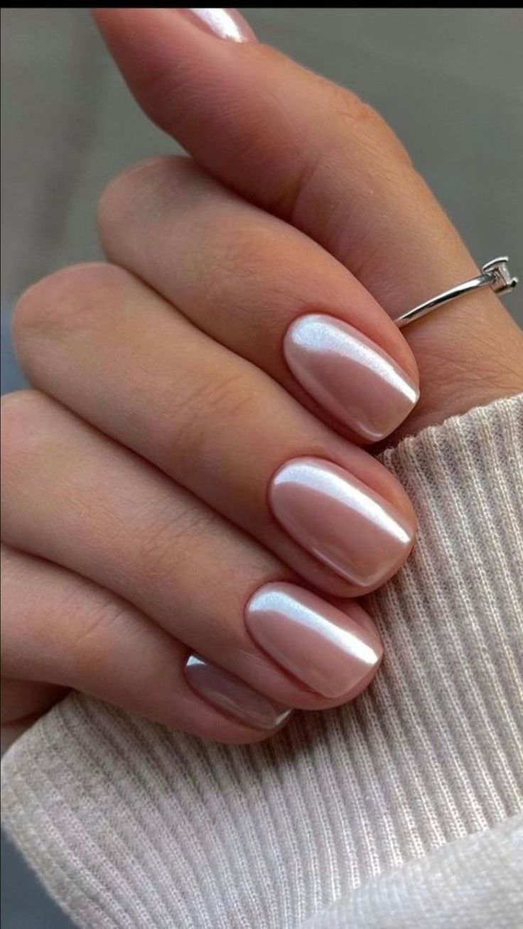 Elegant Nude Nails: A Soft, Timeless Design Enhanced by Iridescence and Silver Jewelry.