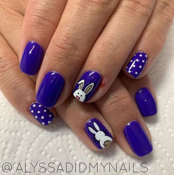 Festive Purple Nails featuring Bunny Designs and Polka Dots for a Cheerful Look.