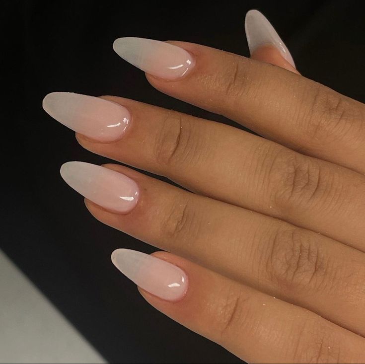 Elegant Ombre Almond-Shaped Nails: Translucent White to Soft Pink Gradient for All Occasions.