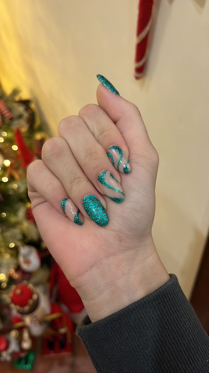 Glamorous Teal Glitter Nail Design with Elegant Swirls for Festive Occasions.