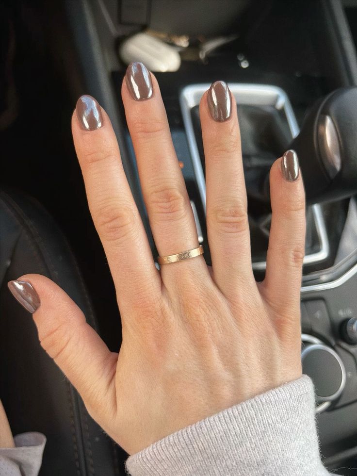 Sophisticated Glossy Taupe Nail Design Enhanced by Simple Gold Ring