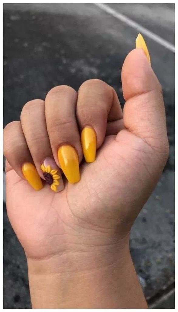 Cheerful Yellow Nail Design with Glossy Finish and Sunflower Accent.