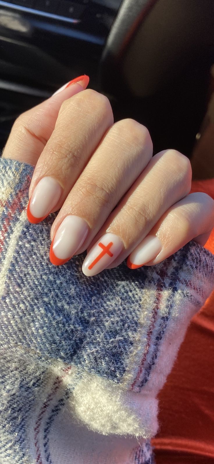 Chic Nail Design: Subtle French Tips Meet Bold Red Accents for Individual Expression.