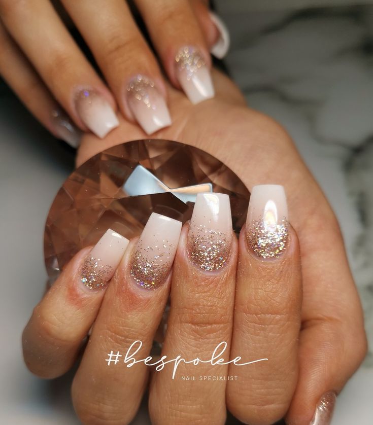 Chic Elegant Ombre Nails: Soft Pink to White with Glitter Accents.