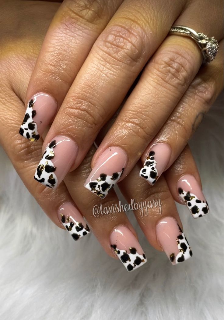 Chic Animal Print Nail Design with Nude Base and Glamorous Gold Accents.