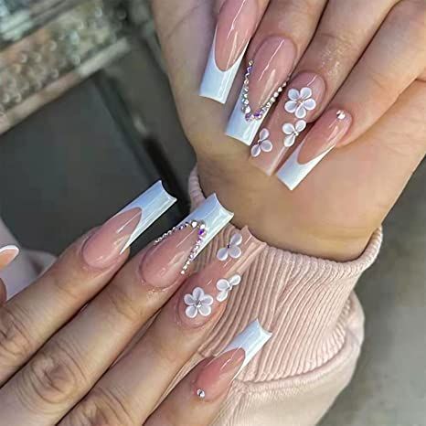 Sophisticated Soft Pink and White Nail Design with Floral Accents and Rhinestones.