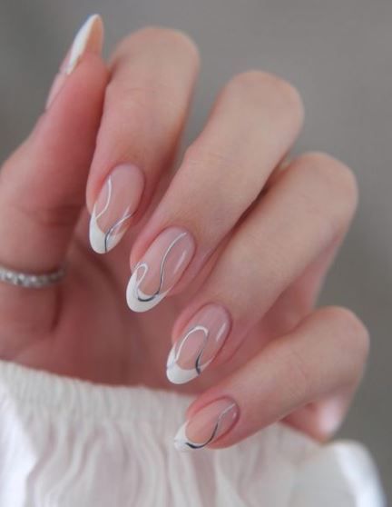 Sophisticated Natural Nude French Tip Nail Design with Elegant Swirls and Modern Black Accents.