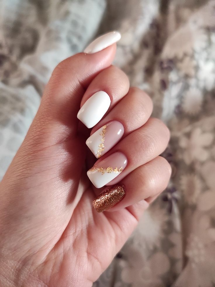 Chic Elegant Nail Design in Classic White and Nude with Glamorous Gold Glitter Accents.