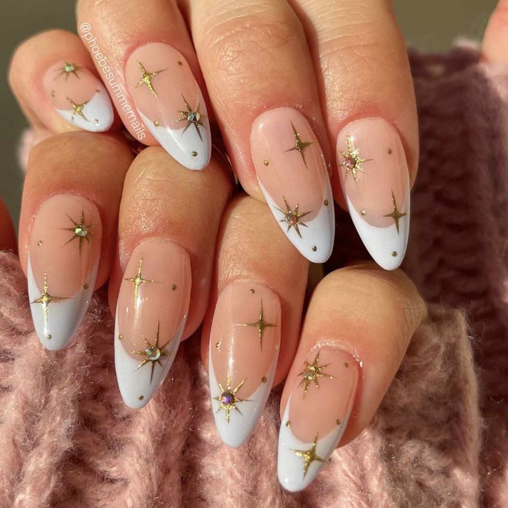 Celestial-Inspired Chic Nail Design: Soft Nude with Glossy Light Blue French Tips and Star Embellishments.