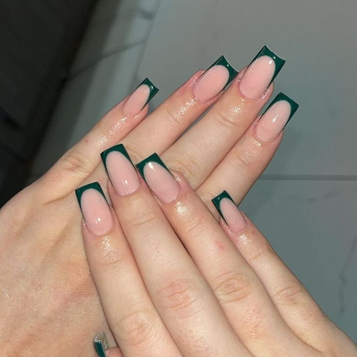 Chic Modern French Tip Manicure with Bold Dark Green Accents on Soft Nude Base