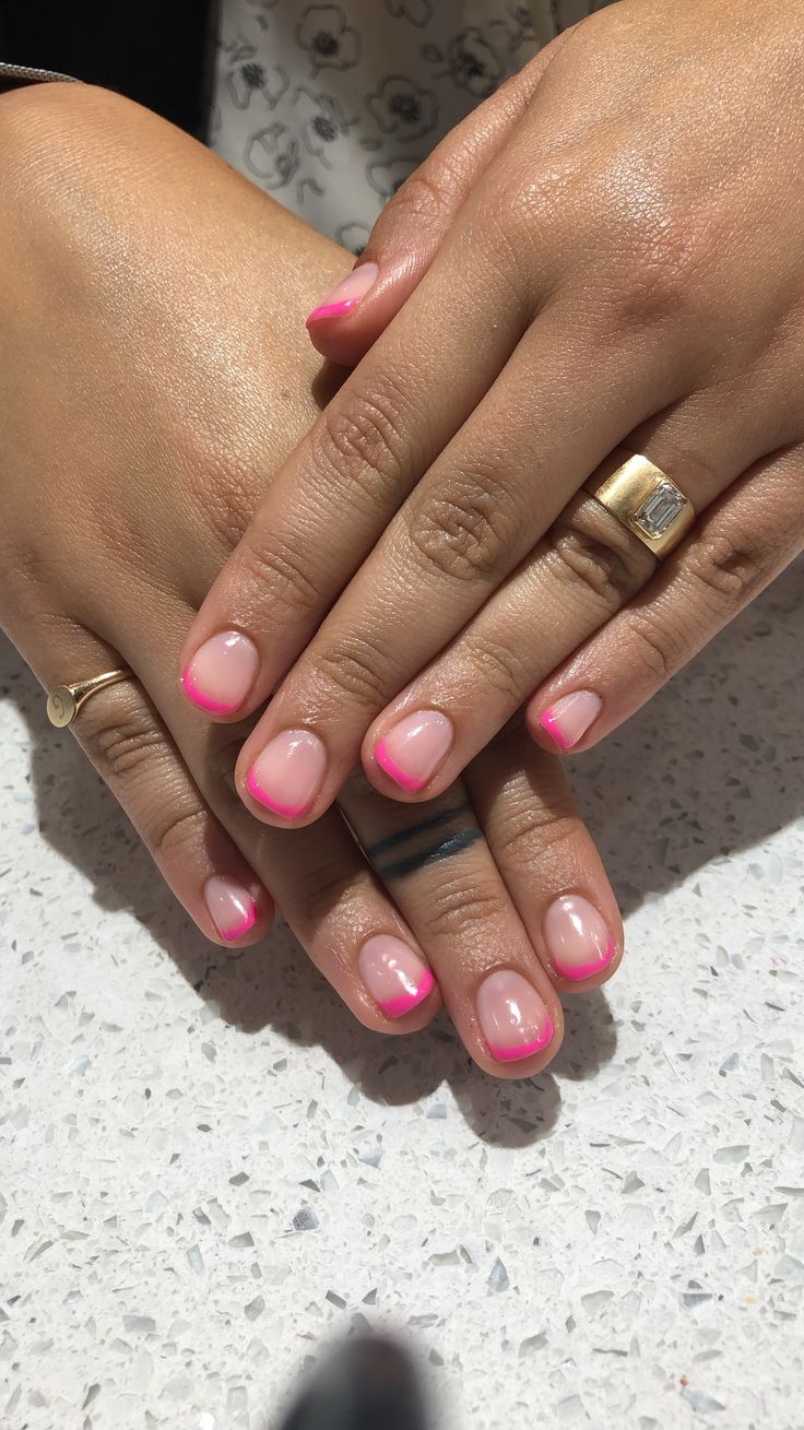 Chic French Tip Nail Design with Bright Pink Accents for a Playful Touch