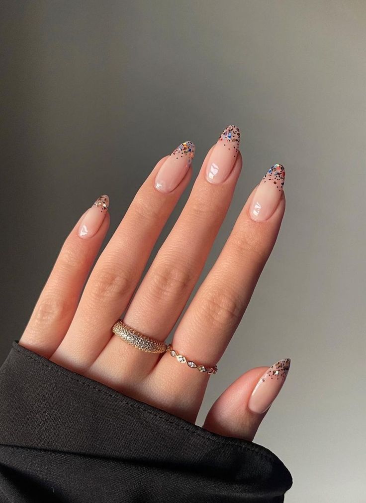 Sophisticated Nude Nail Design with Glitter Tips and Modern Pointed Shape.