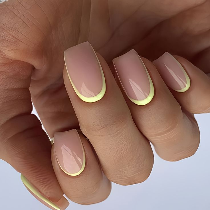 Chic Soft Pink and Vibrant Yellow Nail Design: A Playful Twist on French Manicure Elegance.