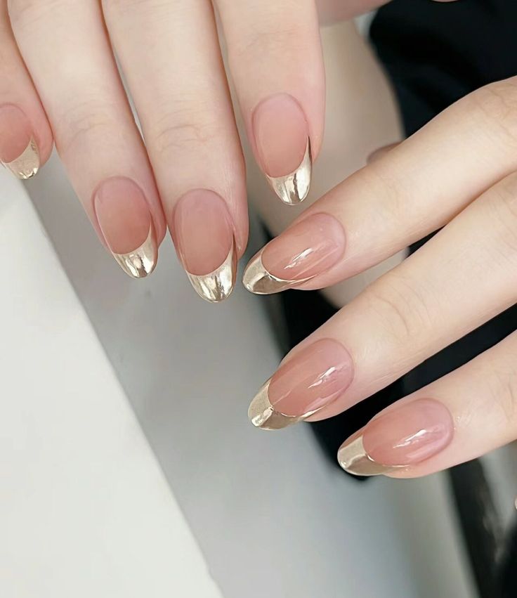 Sophisticated French Tip Nail Design with Glossy Gold Finish and Natural Nude Base.