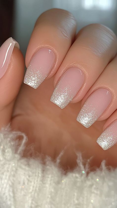 Sophisticated Ombre Nail Design: Soft Pink Base with Sparkling White Tips and Glossy Finish