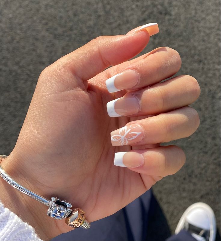 Elegant French Manicure with Floral Accents for Effortless Charm.