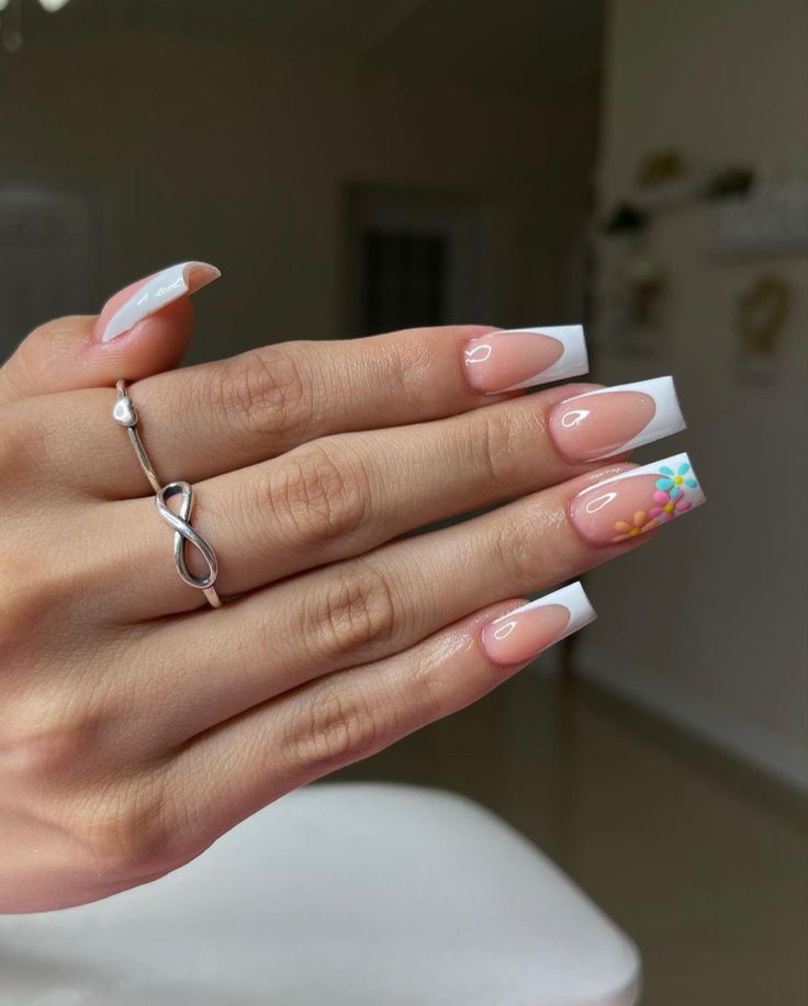 Sophisticated Almond-Shaped French Manicure with Floral Accents.