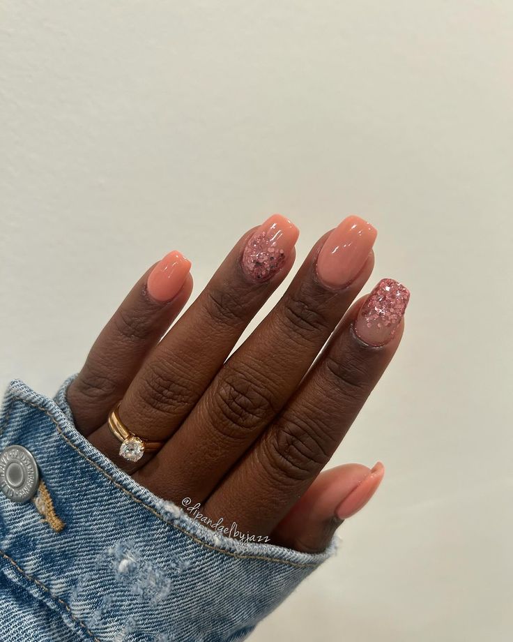 Elegant Soft Peach Nail Design with Sparkling Pink Glitter Accents.