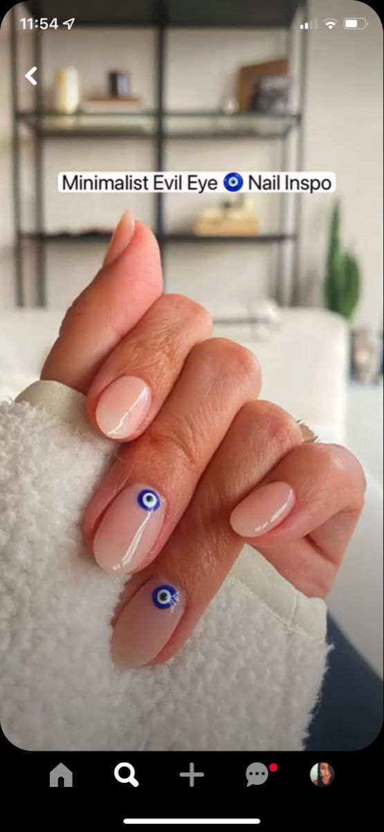 Chic Minimalist Nails: Soft Nude Base with Playful Evil Eye Motif