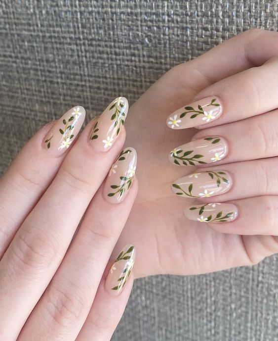 Elegant Floral Nail Design with Delicate Leaves and White Flowers on a Nude Base.