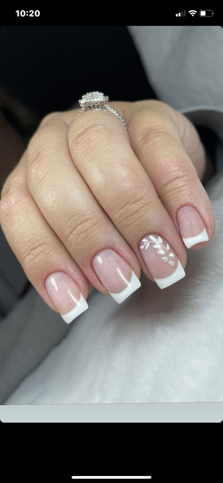 Chic French Manicure with Modern Elegance: Soft Pink Base, White Tips, and Delicate Leaf Patterns.