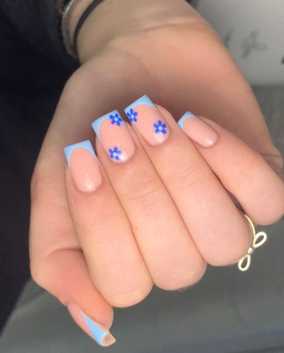 Elegant Blue and Nude Nail Design with Floral Accents for a Fresh Seasonal Vibe.