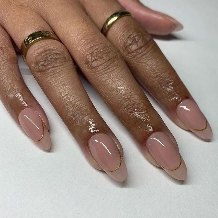 Chic Nude Nail Design with Contrasting Tips and Gold Accents