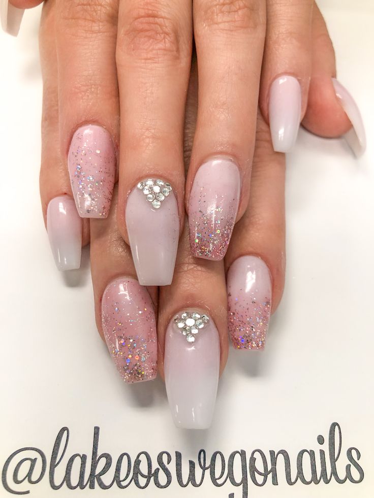 Glamorous Ombre Nail Design with Sparkling Glitter and Rhinestone Accents.