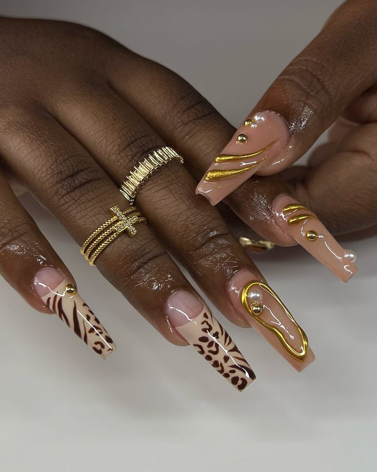 Chic Nail Art: Elegant Shapes and Playful Animal Prints Enhanced with Gold Accents and Decorative Elements.