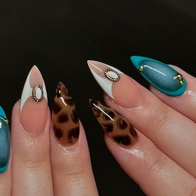 Vibrant Stiletto Nail Design with Leopard Print, Teal, and Metallic Accents.