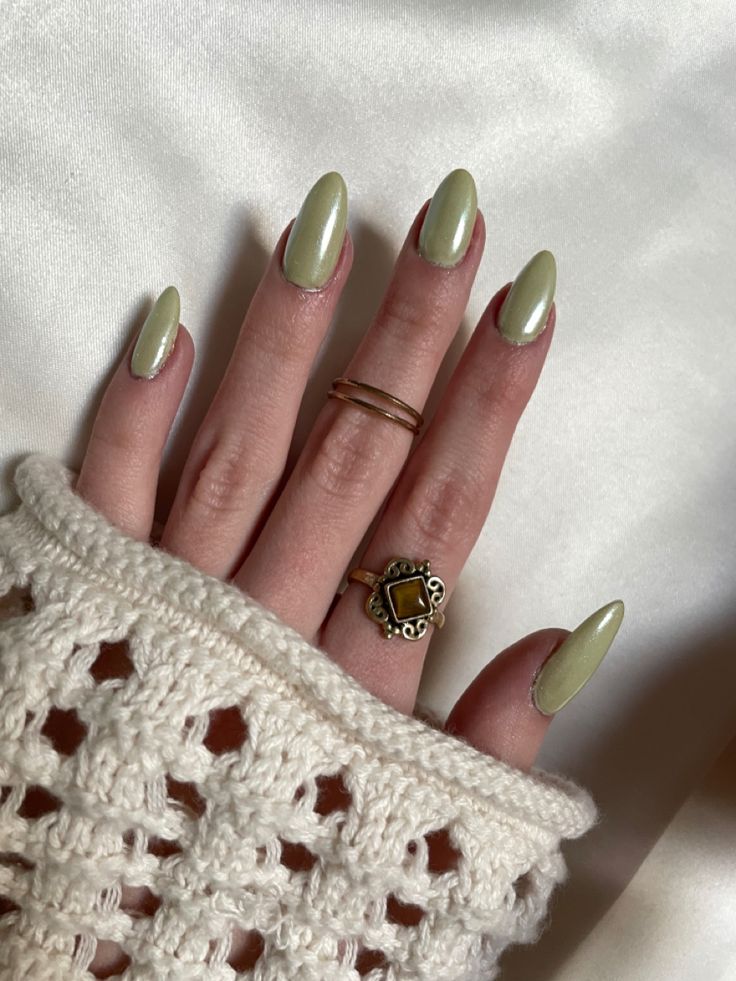 Chic Pastel Green Almond-Shaped Nails Paired with a Cozy Sweater for a Fresh Aesthetic.