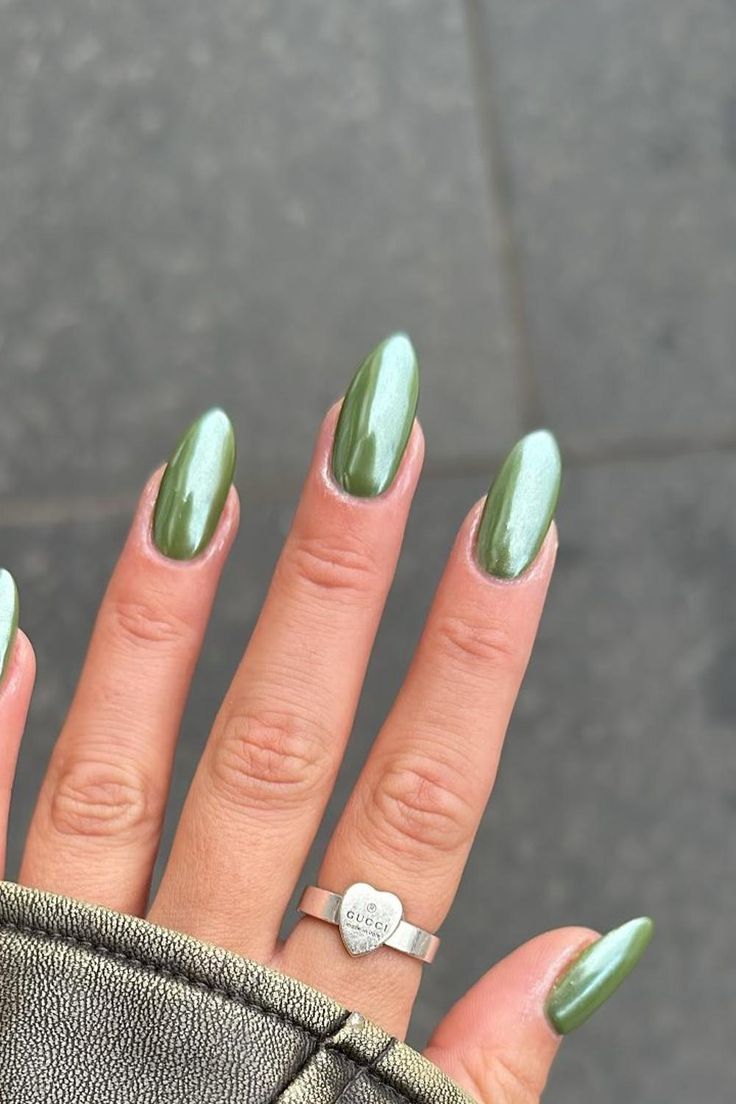 Sophisticated Almond-Shaped Green Nails with Glossy Finish and Silver Ring Accent