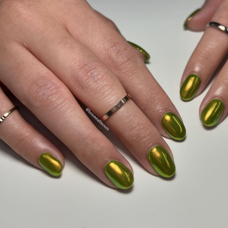 Vibrant Metallic Green Nail Design with Shiny Oval Shape and Elegant Gold Rings