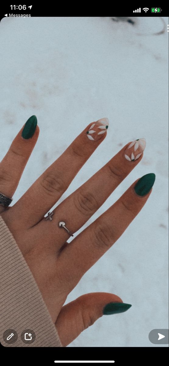 Stunning Nail Art: Bold Deep Green and Elegant White Geometric Floral Design.