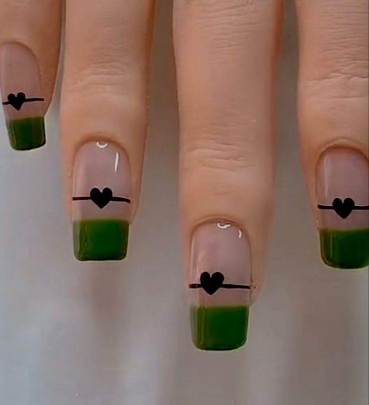 Chic Nail Design: Earthy Green French Tips with Minimalist Black Hearts and Lines.