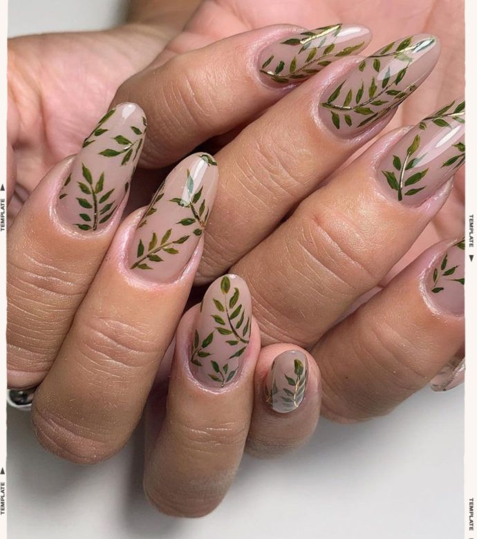 Elegant Nude Nails with Delicate Green Leaf Designs for Nature Lovers