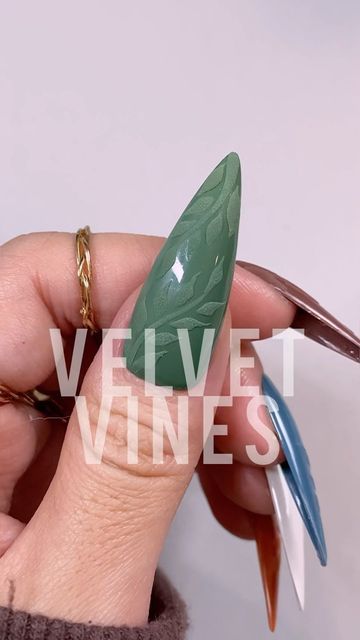 Chic Textured Green Stiletto Nails with Elegant Leaf Pattern and Glossy Matte Contrast.