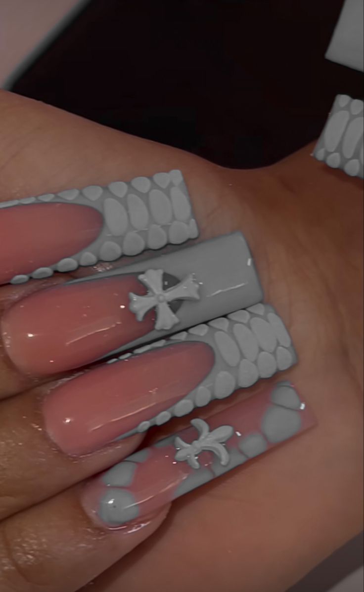 Trendy Nail Design: Soft Pink and Textured Gray with Pebble-Inspired Accents.