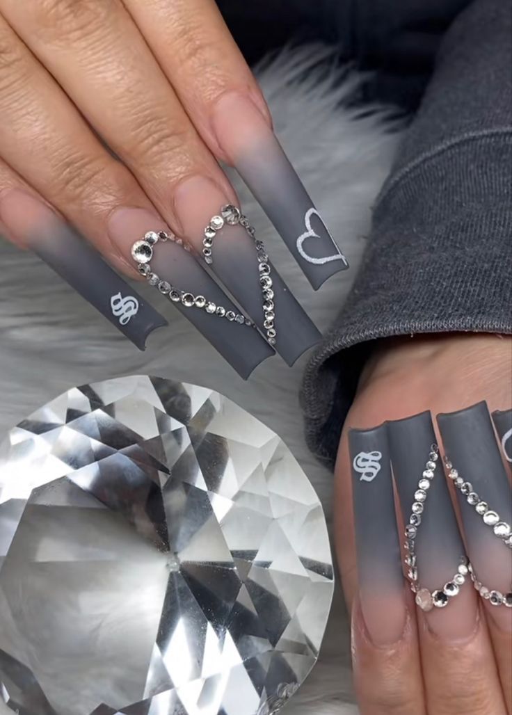 Chic Long Matte Gradient Gray Nails Adorned with Elegant Rhinestone Heart Patterns.